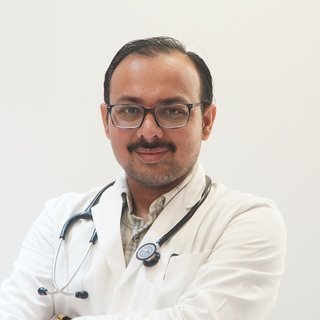 Portrait of Dr. Jaydipsinh B. Bhati wearing a white coat, glasses and stethoscope.