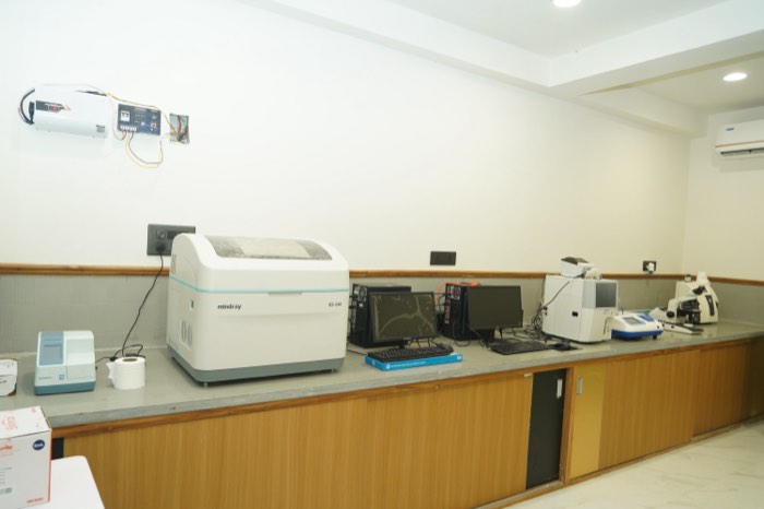 Inside Perfect Pathology Laboratory: a Mindray BS-240 analyser, workstation computers and a microscope along the bench.